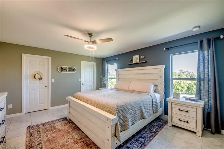 Bedroom featuring light tile patterned floors and a ceiling fan
