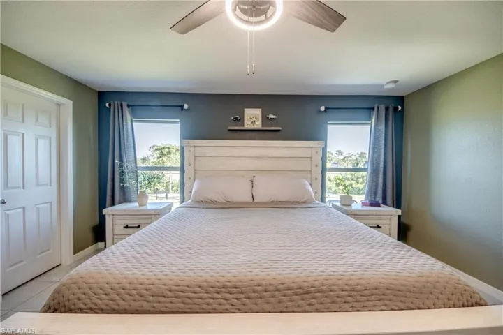 Bedroom featuring a ceiling fan and light tile patterned flooring