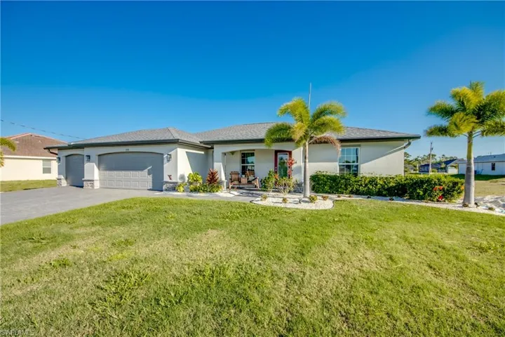 Ranch-style house with an attached garage, concrete driveway, a front lawn, and stucco siding