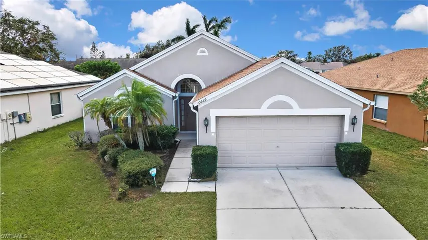 Single story home with a garage and a front yard
