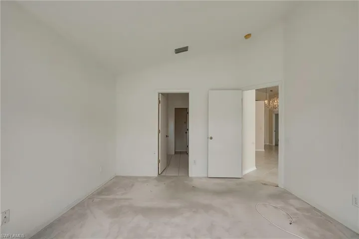 Spare room featuring vaulted ceiling