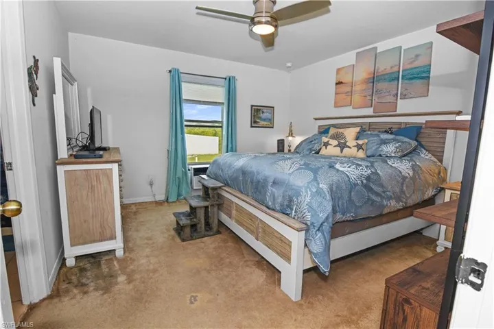 Bedroom featuring ceiling fan and carpet floors