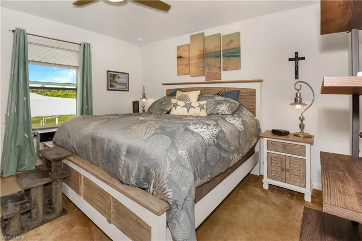 Carpeted bedroom featuring a ceiling fan