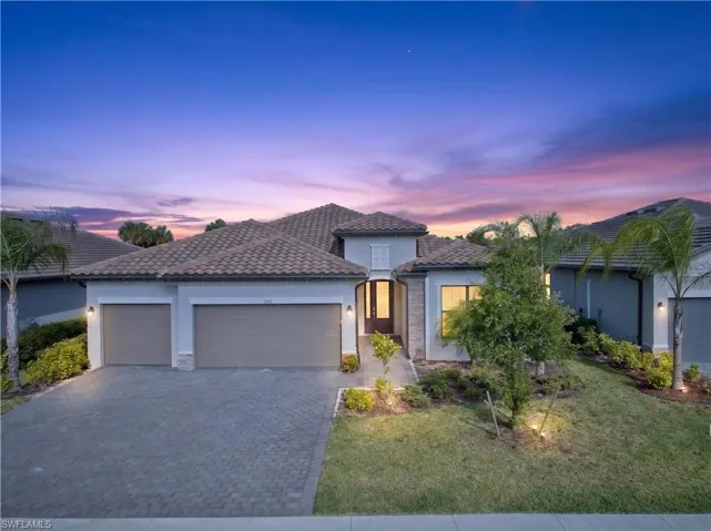 Contemporary facade featuring a tile roof and stone accents