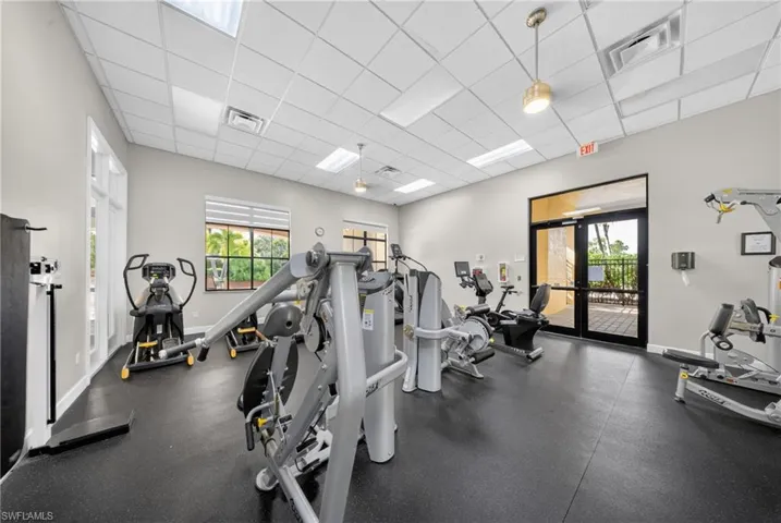 Fitness center featuring rubber flooring, recessed lighting, and multiple exercise machines