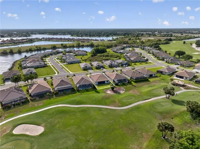 Aerial perspective showcasing a residential community with golf course frontage