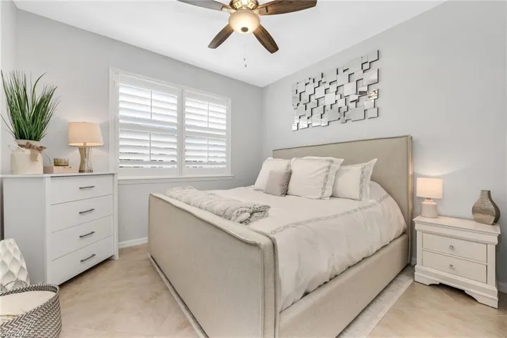 Bedroom with a ceiling fan and light tile patterned floors