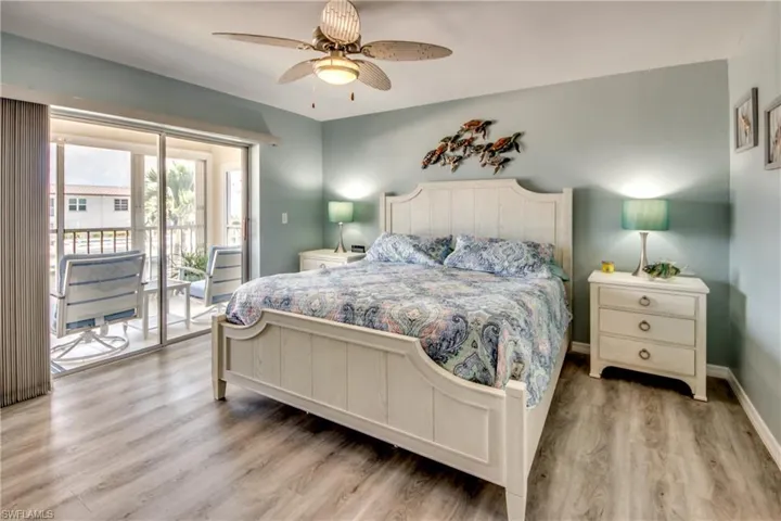 Bedroom with Sliders to Screened-in Lanai, ceiling fan, and Walk-in Closet.