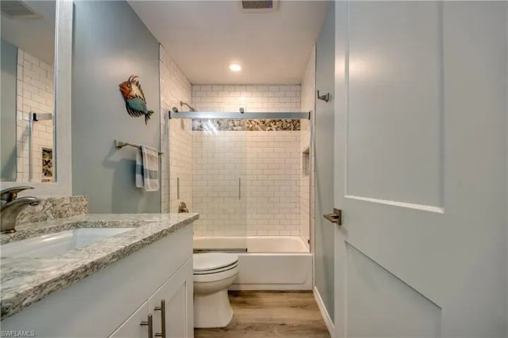 Full Guest Bathroom featuring tiled shower, Quartz Counters, New Lighting.