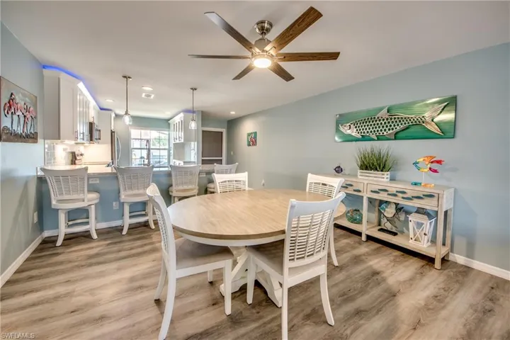 Dining area featuring light wood-type flooring and ceiling fan