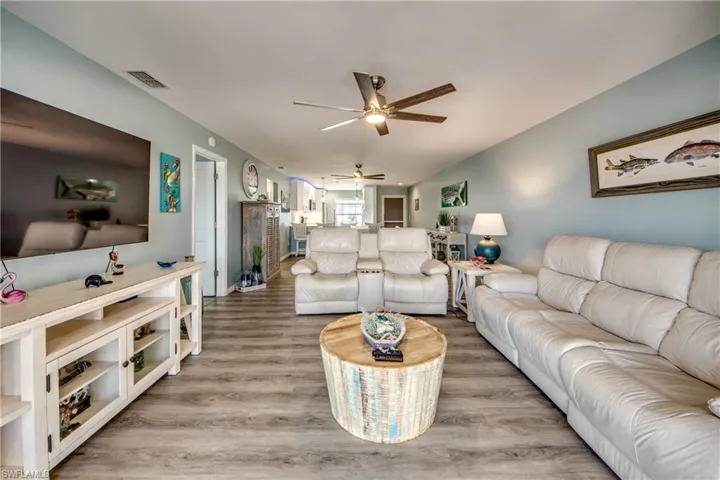 Living room featuring ceiling fan and hardwood / wood-style flooring