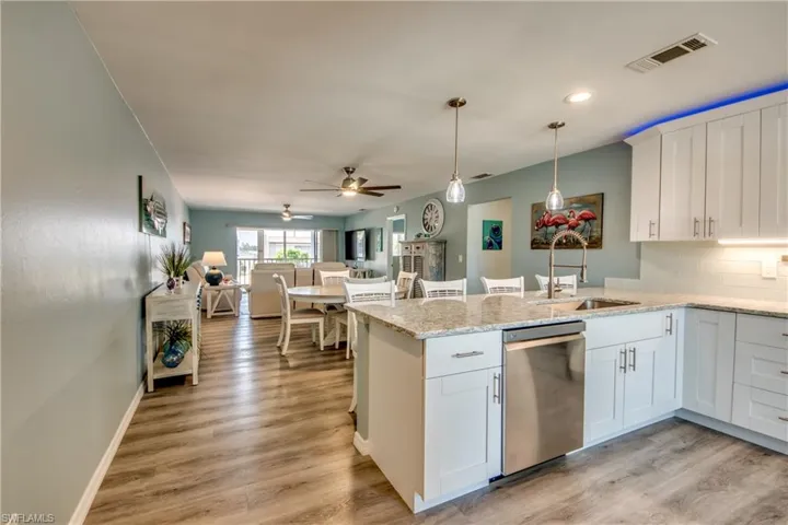 Tastefully Updated with White Cabinets, Custom Lighting & View to Lanai/Canal.