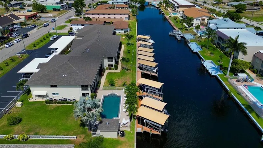 Birds eye view of property with a water view