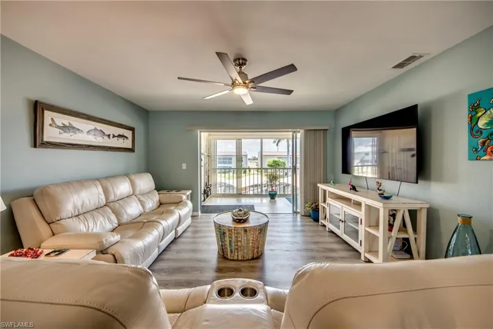 Living room with hardwood / wood-style floors and ceiling fan