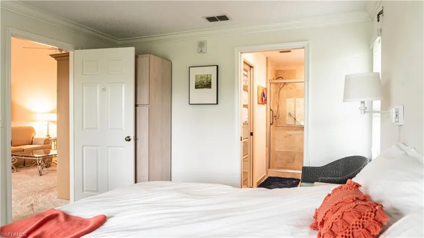 Bedroom featuring ornamental molding and carpet flooring