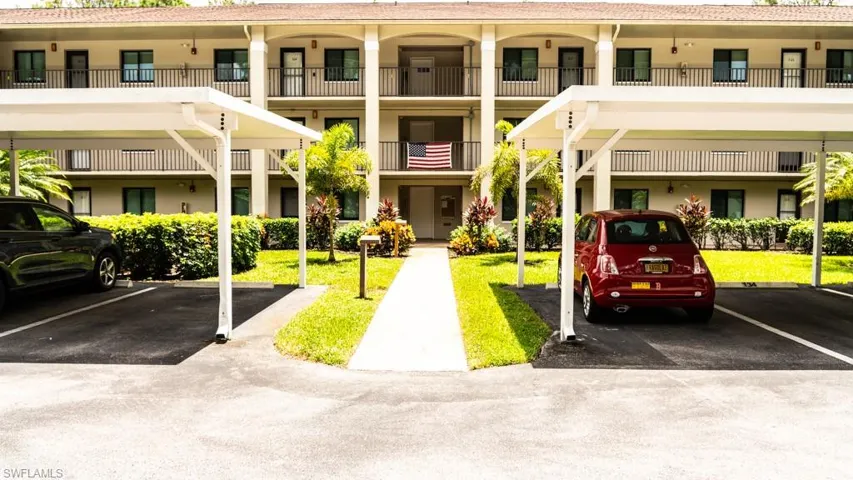 View of property with covered parking
