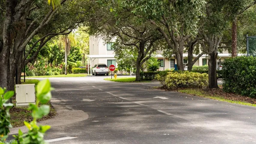 View of asphalt road with traffic signs
