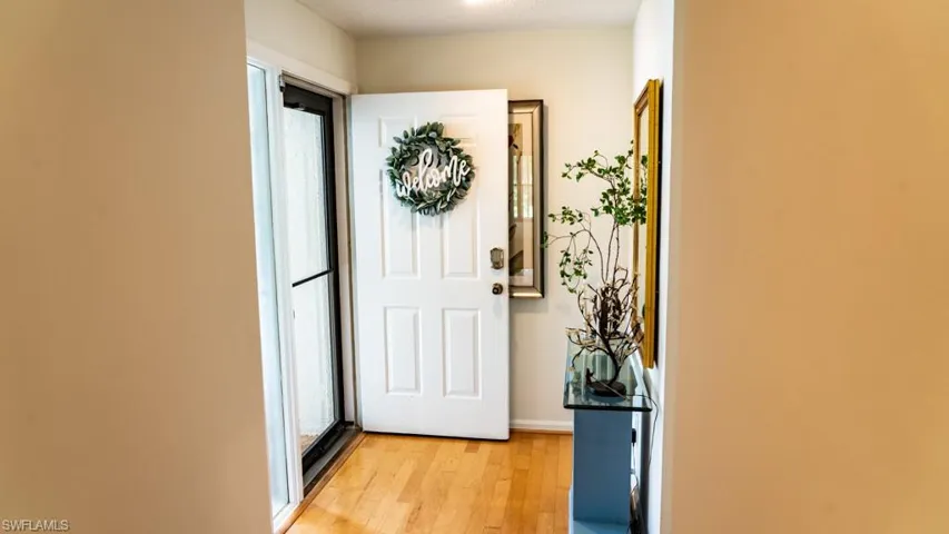 Doorway with light wood-style floors and baseboards
