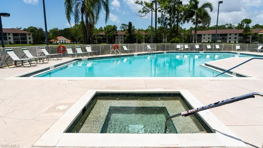 Community pool with a patio and a community hot tub