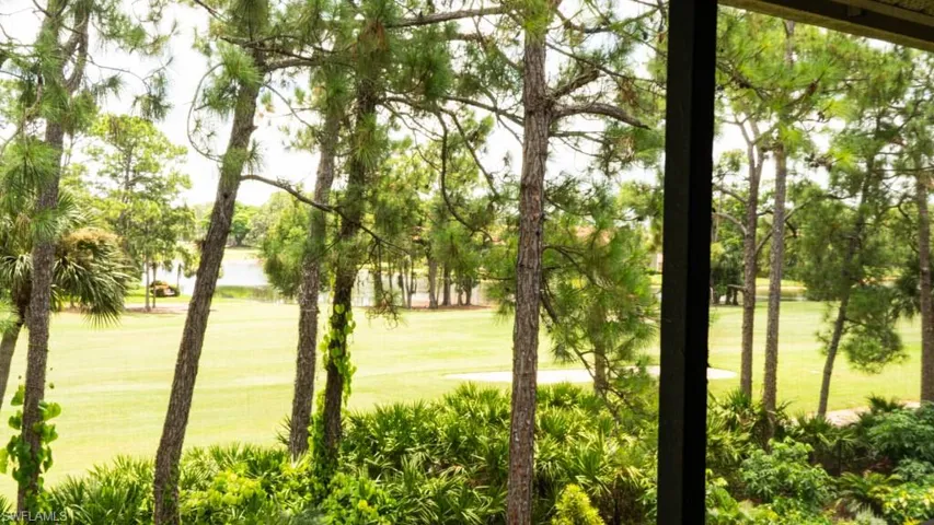 Surrounding community with a lawn and golf course view