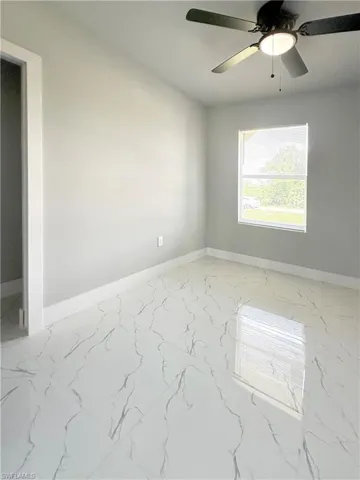 Spare room with ceiling fan