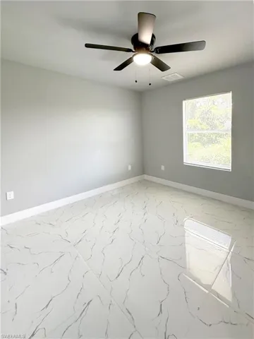 Empty room featuring ceiling fan