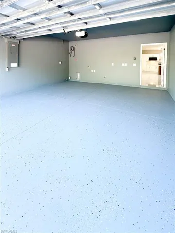 Garage with electric panel and a garage door opener