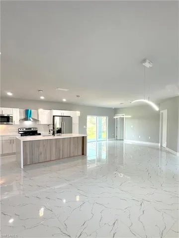 Unfurnished living room with sink