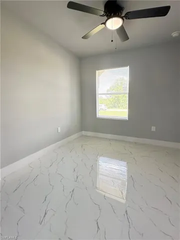 Unfurnished room featuring ceiling fan