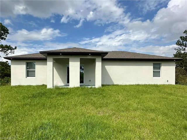 Rear view of property featuring a yard