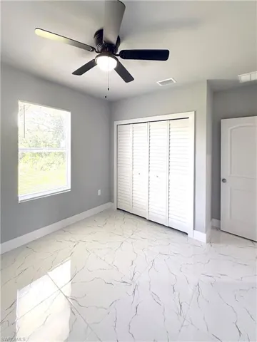 Unfurnished bedroom featuring ceiling fan and a closet