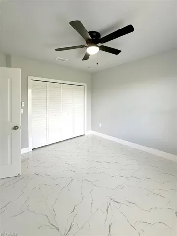 Unfurnished bedroom featuring a closet and ceiling fan