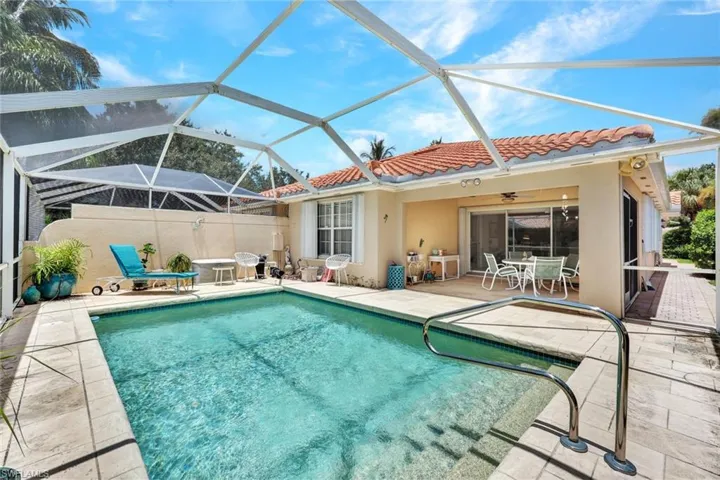 View of pool featuring a patio and screened enclosure