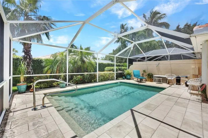 View of swimming pool with a lanai and a patio
