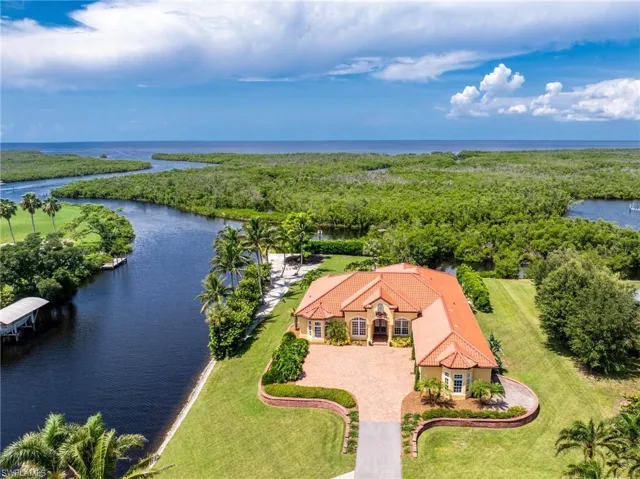 Aerial view of property and surrounding area featuring a large body of water