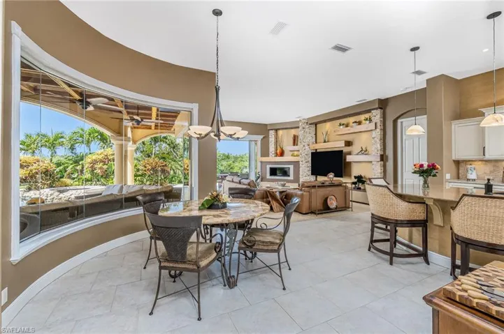 Dining space featuring light tile patterned floors and suspended lighting