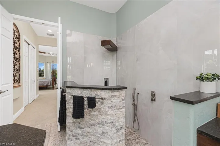 Ensuite bathroom with a walk in shower and light carpet
