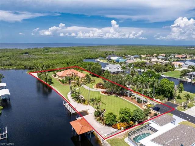 Aerial view of residential area featuring a nearby body of water