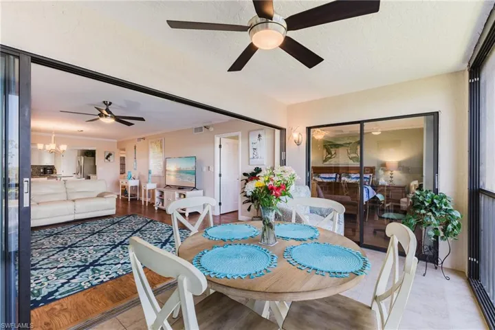 Dining room featuring a ceiling fan, suspended lighting, and a textured ceiling