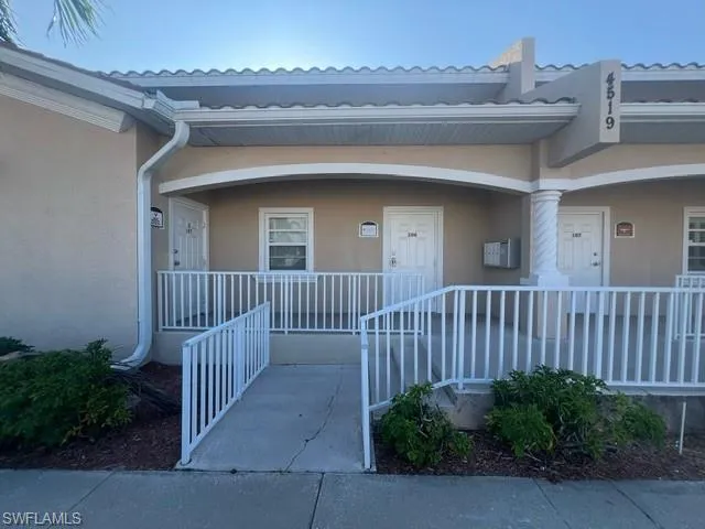 Property entrance with covered porch and ramp