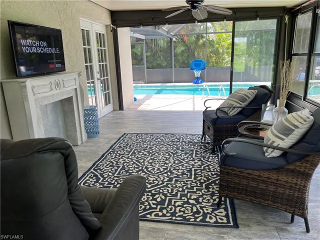 Outdoor pool with a patio, a sunroom, a lanai, and french doors