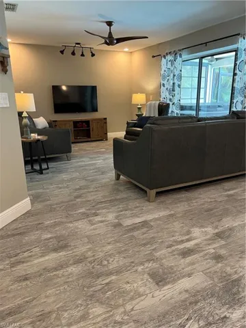 Living room featuring a ceiling fan and wood finished floors