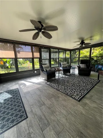 Sunroom / solarium featuring ceiling fan and an outdoor hangout area