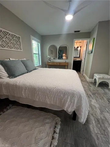 Bedroom with a ceiling fan and wood finished floors