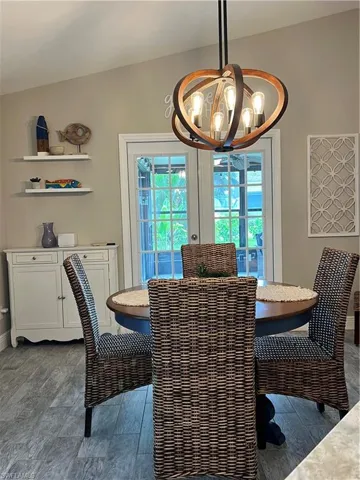 Dining space featuring a chandelier and baseboards