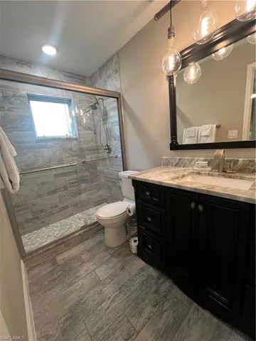 Bathroom with vanity and a shower stall