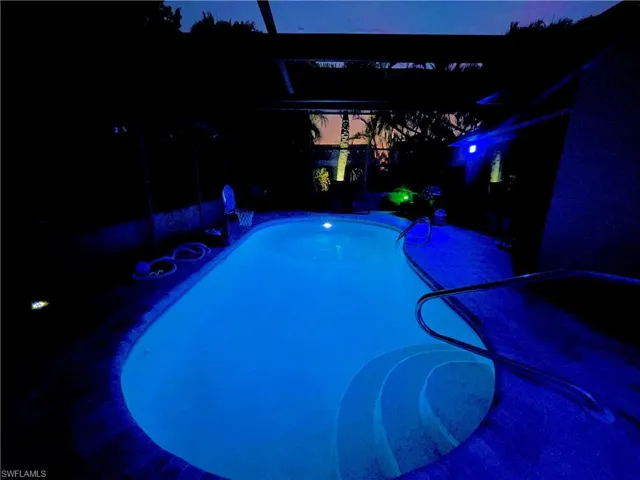 Swimming pool with a pergola, a lanai, and a patio