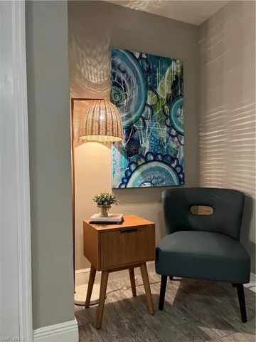 Sitting room with wood finished floors and baseboards
