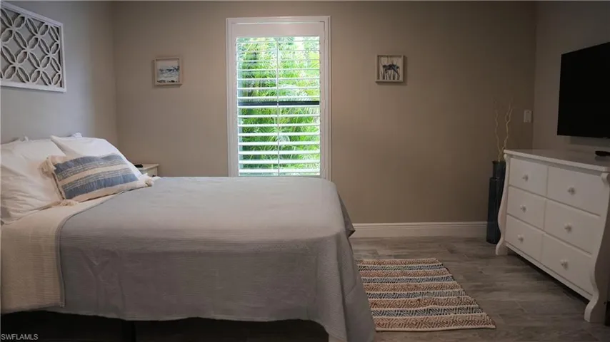 Bedroom featuring baseboards and light wood-type flooring