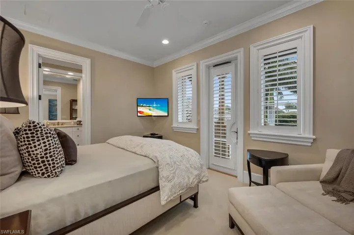 Bedroom featuring access to exterior, light colored carpet, a ceiling fan, recessed lighting, and crown molding